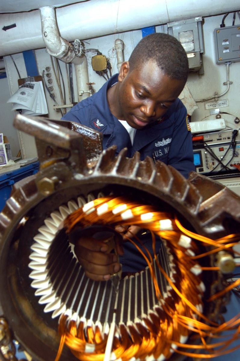 An electrician rewiring a pump motor