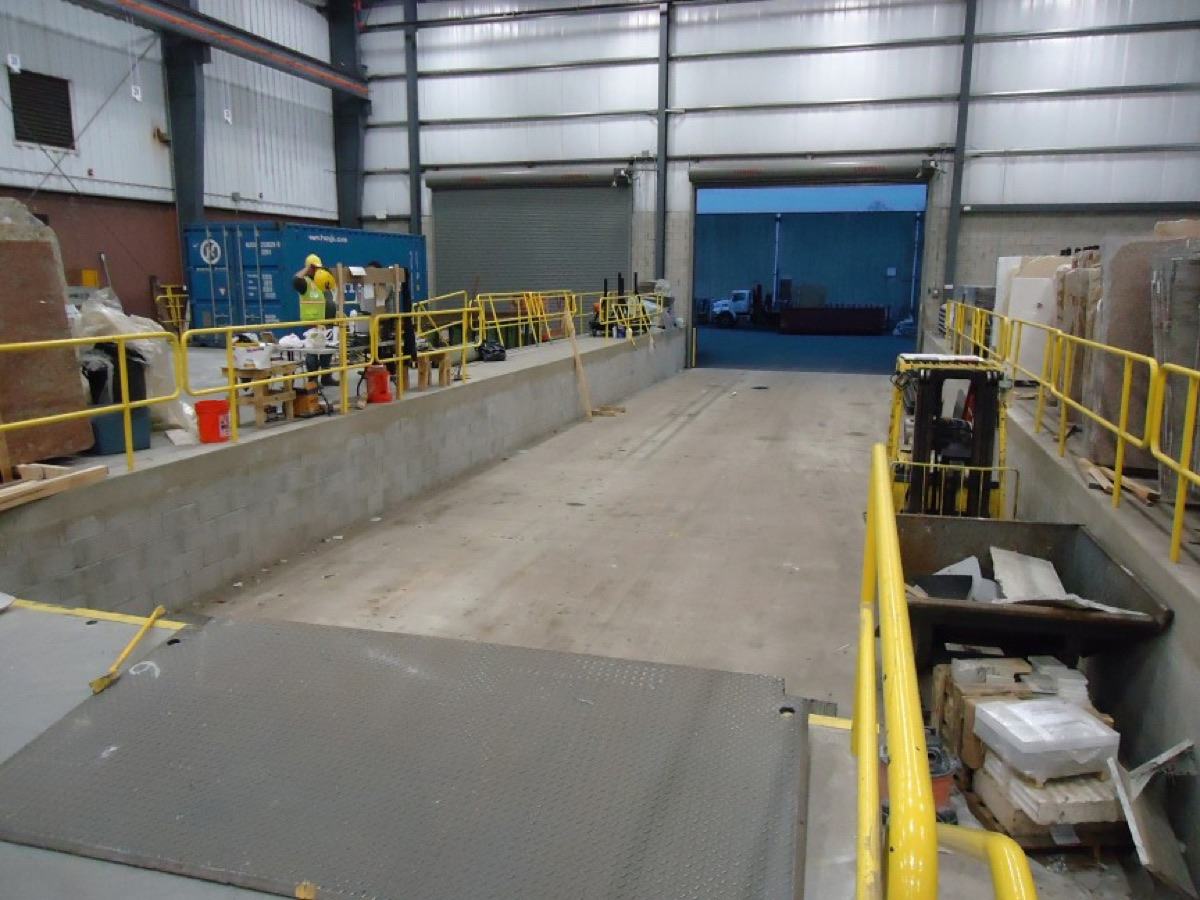 Inside a warehouse loading bay with yellow guard rails